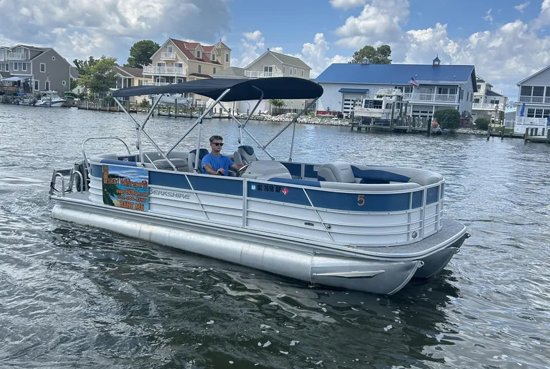 Slide: The Image of 2024 Berkshire 24RFX LE 2.75 pontoon boat on a scenic waterway. - 17