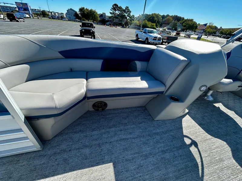 Slide: The Image of 2024 Berkshire 24RFX LE 2.75 pontoon boat interior with gray seating in a parking lot. - 7