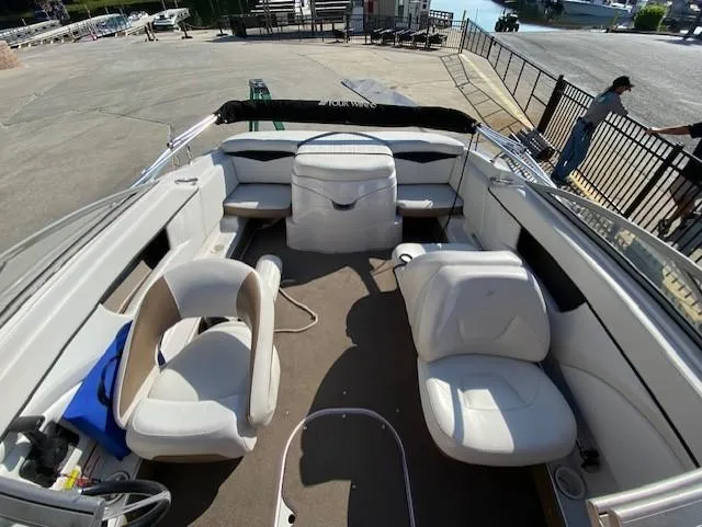 Slide: The Image of 2007 Four Winns 200 Horizon boat interior with white seating and open deck layout. - 7