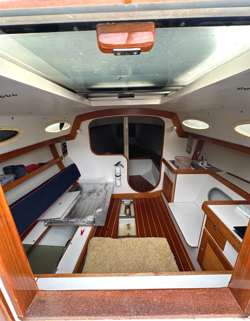 Slide: The Image of Interior of 2005 Express Alerion sailboat with wood accents and seating area. - 10