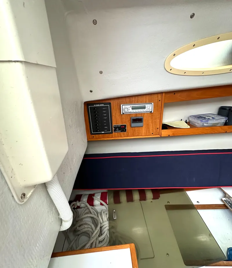 Slide: The Image of Interior of 2005 Express Alerion sailboat with control panel and storage shelves. - 11