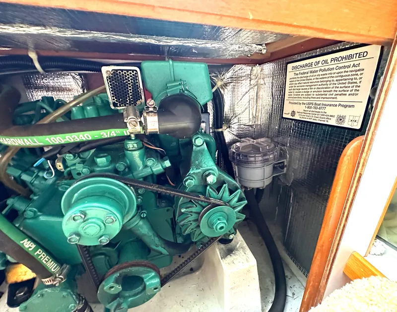 Slide: The Image of Engine compartment of a 2005 Express Alerion sailboat with oil discharge warning sign. - 16