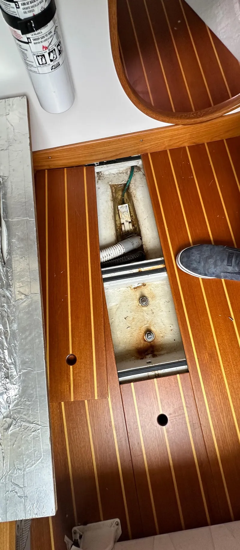 Slide: The Image of Wooden boat floor with open hatch, revealing interior components. Express Alerion 2005 model. - 17