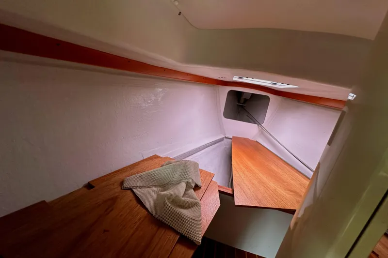 Slide: The Image of 2005 Express Alerion cabin interior with wooden surfaces and a small window. - 18