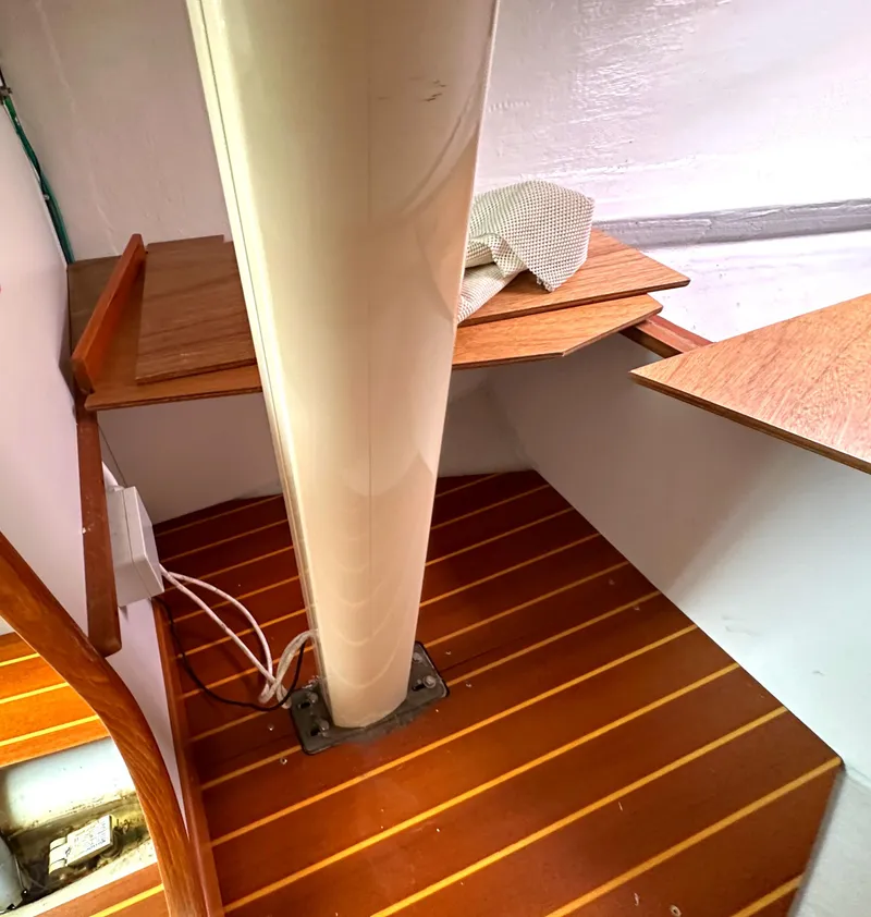 Slide: The Image of 2005 Express Alerion interior with wooden flooring and mast detail. - 19