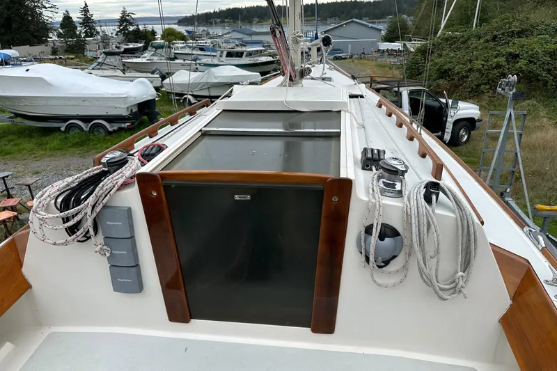 Slide: The Image of 2005 Express Alerion sailboat deck with ropes and equipment in a marina setting. - 26