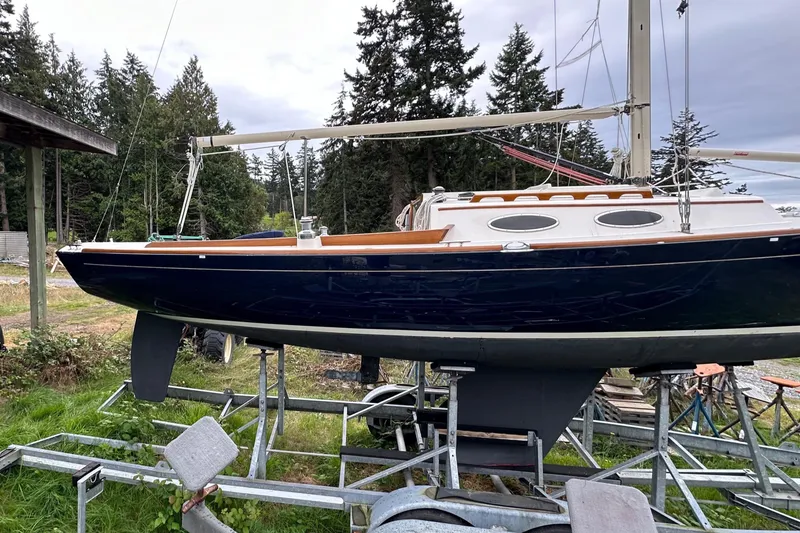 Slide: The Image of 2005 Express Alerion sailboat on trailer, surrounded by trees and grass. - 27