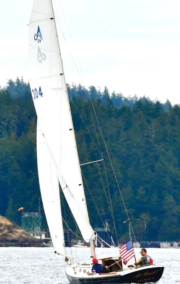 Slide: The Image of 2005 Express Alerion sailboat on water with forested background. - 3