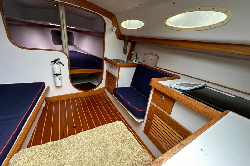 Slide: The Image of 2005 Express Alerion sailboat interior with wood accents and blue seating. - 34