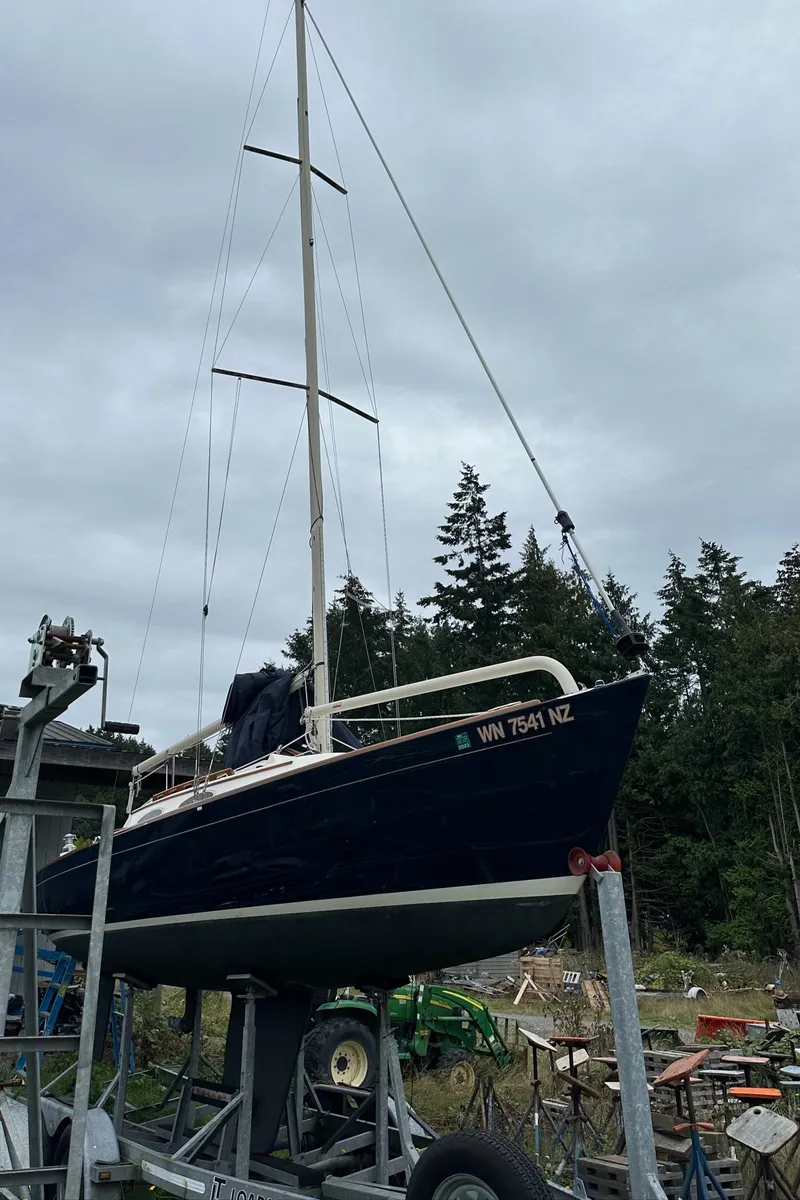 Slide: The Image of 2005 Express Alerion sailboat on trailer, overcast sky, forest background. - 36