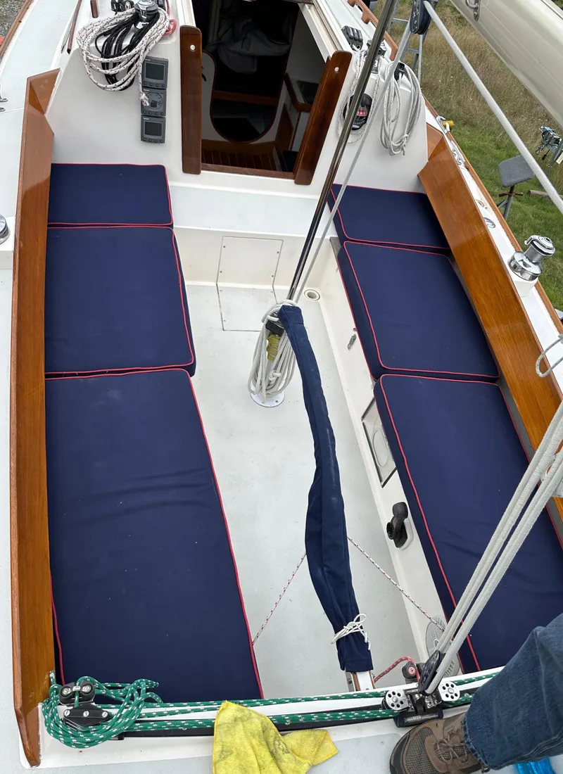 Slide: The Image of 2005 Express Alerion sailboat cockpit with blue cushions and wooden trim. - 38