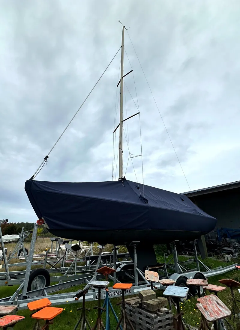Slide: The Image of 2005 Express Alerion sailboat on trailer under cloudy sky. - 5
