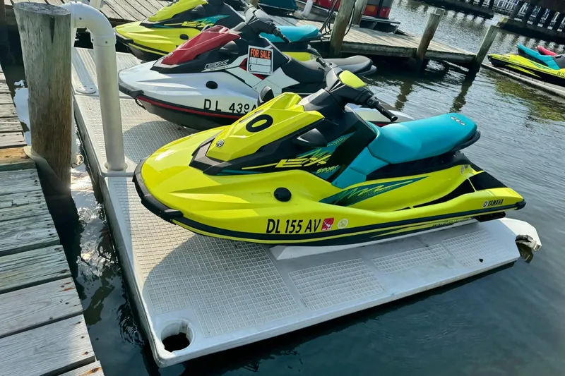 Slide: The Image of 2022 Yamaha WaveRunner EX Sport in vibrant yellow docked at a marina. - 0