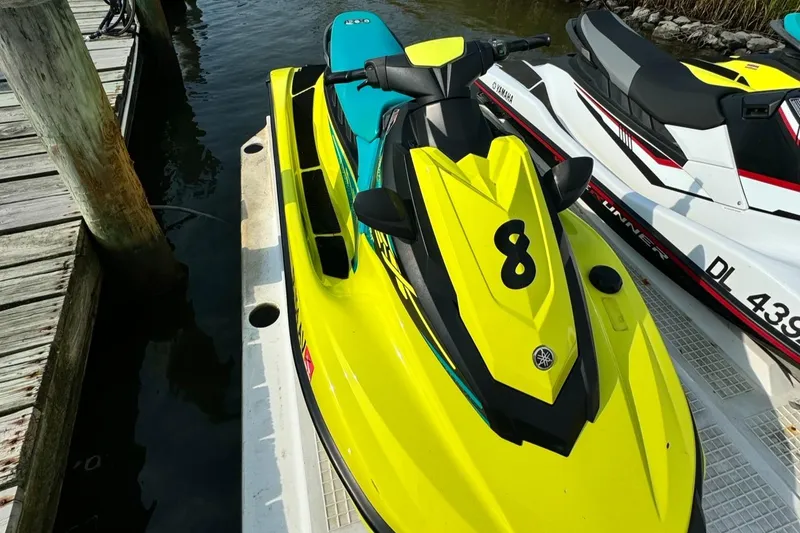 Slide: The Image of 2022 Yamaha WaveRunner EX Sport, bright yellow, docked on water. - 1