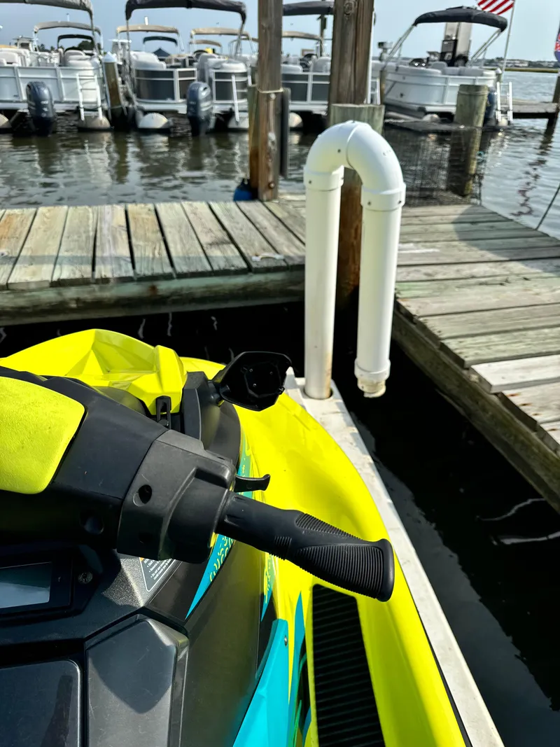 Slide: The Image of 2022 Yamaha WaveRunner EX Sport docked at a marina with boats in the background. - 3