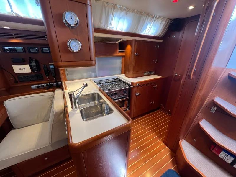 Slide: The Image of Luxurious Nautor Swan 53 yacht interior with modern kitchen, wood finish, and cozy seating, 2013 model. - 14