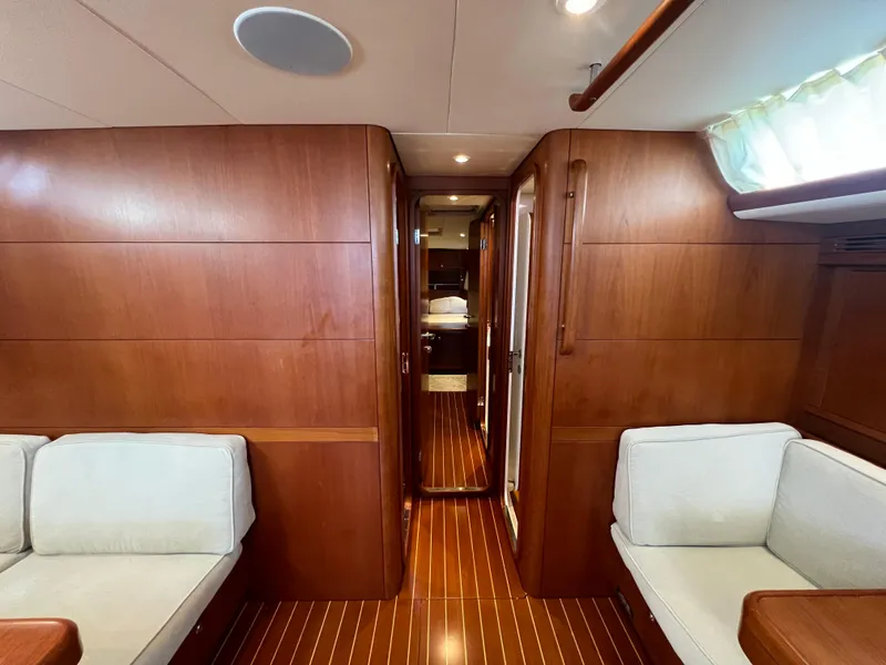 Slide: The Image of Luxurious interior of 2013 Nautor Swan 53 yacht with wooden paneling and white seating. - 15