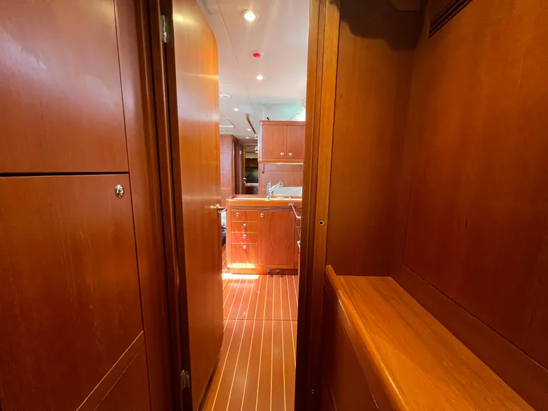 Slide: The Image of Interior view of 2013 Nautor Swan 53 yacht, featuring wooden cabinetry and flooring. - 23