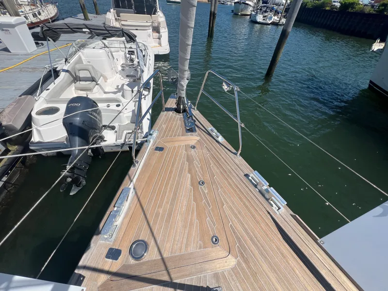 Slide: The Image of Nautor Swan 53 sailboat docked, showcasing teak deck and marina setting, 2013 model. - 3
