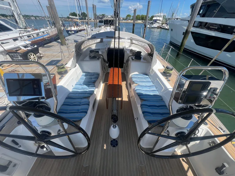 Slide: The Image of Cockpit of 2013 Nautor Swan 53 yacht with dual steering wheels and blue cushions. - 5