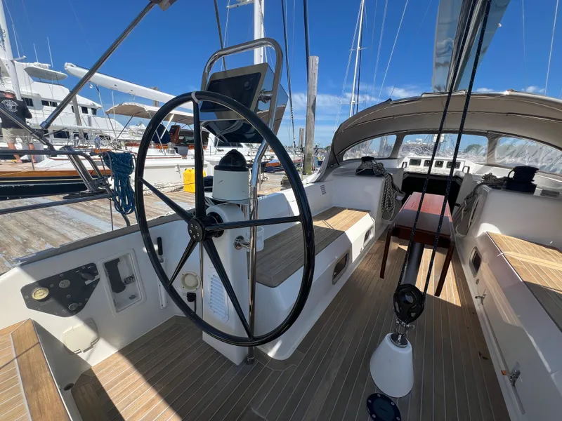 Slide: The Image of Nautor Swan 53 sailboat cockpit, 2013 model, featuring a sleek steering wheel and wooden deck. - 7