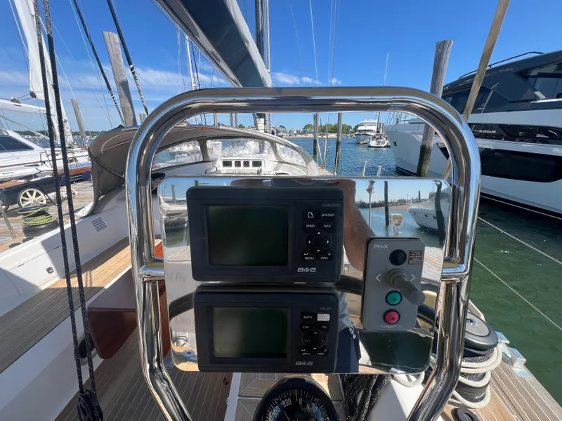 Slide: The Image of Cockpit view of 2013 Nautor Swan 53 yacht with navigation instruments and marina background. - 8