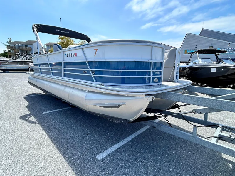 Slide: The Image of 2024 Berkshire 24CL LE 2.75 pontoon boat parked on a trailer in a lot. - 1