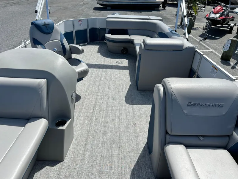 Slide: The Image of 2024 Berkshire 24CL LE 2.75 pontoon boat interior with gray seating and spacious layout. - 6