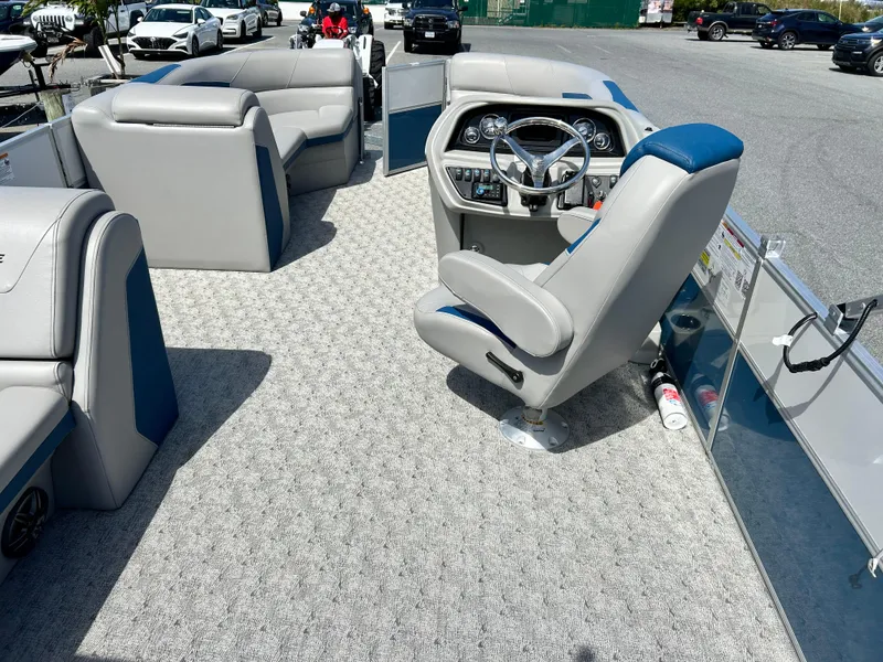 Slide: The Image of 2024 Berkshire 24CL LE 2.75 pontoon boat interior with steering console and seating. - 7