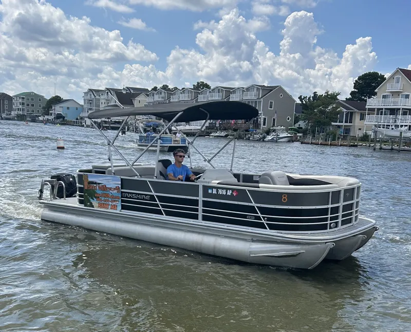 Slide: The Image of 2024 Berkshire 24CL LE 2.75 pontoon boat cruising on a sunny day. - 20