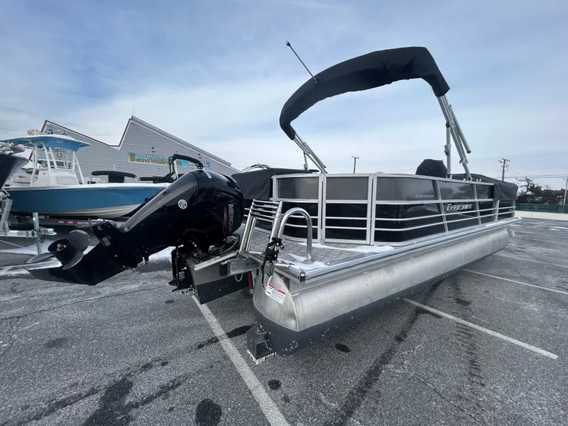 Slide: The Image of 2024 Berkshire 24CL LE 2.75 pontoon boat with outboard motor in a parking lot. - 3