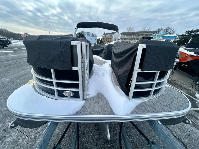 Slide: The Image of 2024 Berkshire 24CL LE 2.75 pontoon boat covered, parked outdoors on a cloudy day. - 5