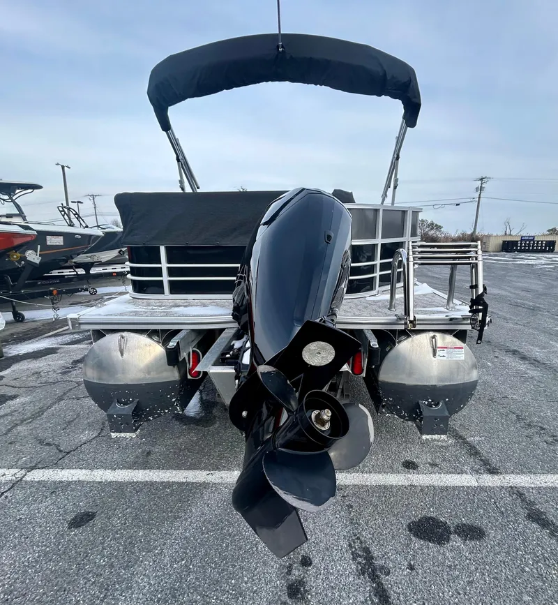 Slide: The Image of 2024 Berkshire 24CL LE 2.75 pontoon boat with outboard motor, parked on asphalt. - 7