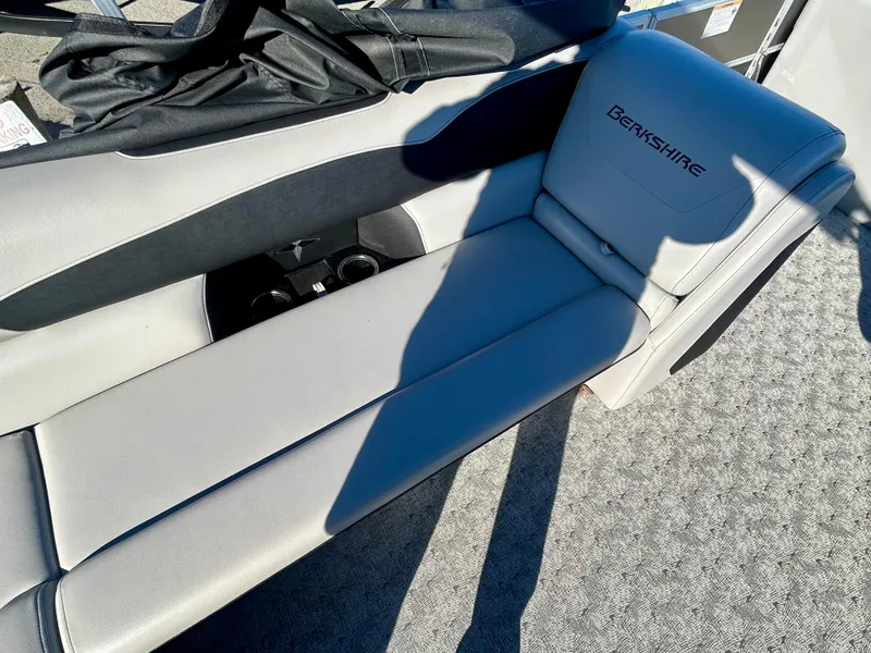 Slide: The Image of 2024 Berkshire 24CL LE 2.75 boat interior with gray seating and cup holders. - 9