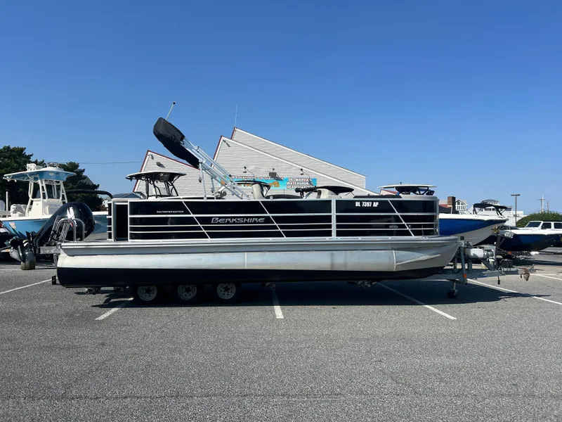The Image of 2024 Berkshire 24CL LE 2.75 pontoon boat on trailer in parking lot. - 0