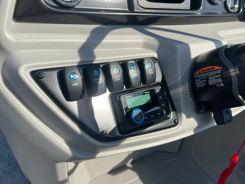 Slide: The Image of Control panel of 2024 Berkshire 24CL LE 2.75 boat with switches and display. - 12