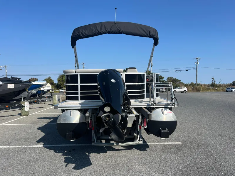 Slide: The Image of 2024 Berkshire 24CL LE 2.75 pontoon boat with outboard motor in parking lot. - 4