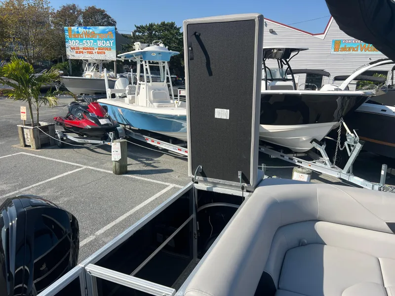 Slide: The Image of 2024 Berkshire 24CL LE 2.75 pontoon boat in a marina with other boats. - 8