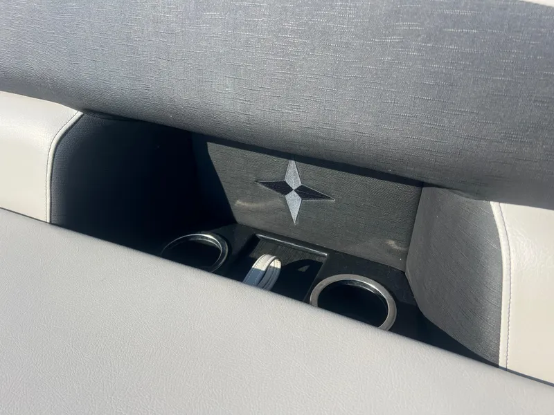 Slide: The Image of 2024 Berkshire 24RFX LE 2.75 boat interior with cup holders and star emblem. - 12
