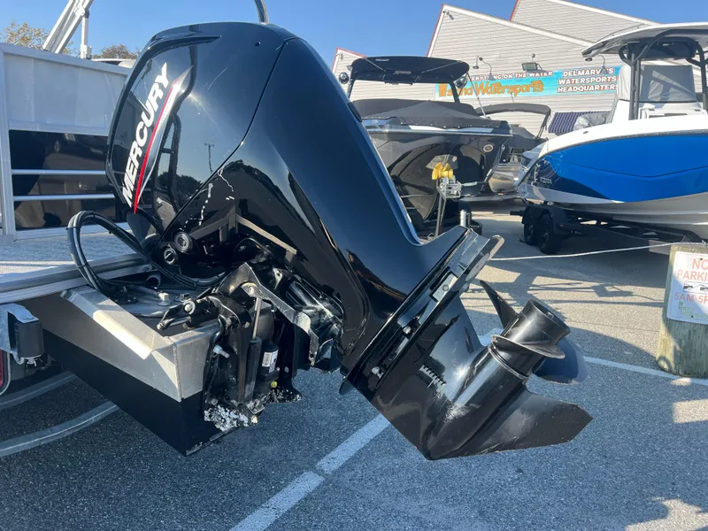Slide: The Image of 2024 Berkshire 24RFX LE 2.75 with Mercury outboard motor in a marina setting. - 15