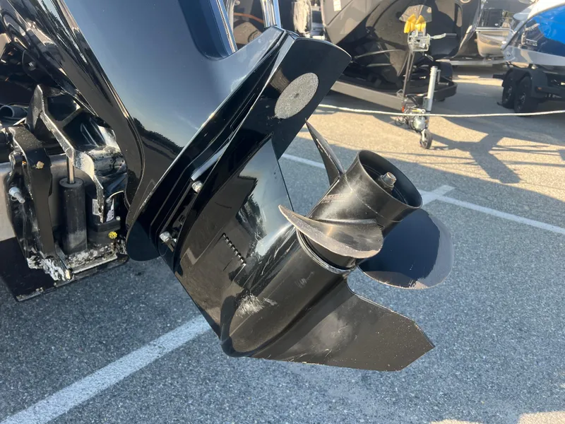 Slide: The Image of 2024 Berkshire 24RFX LE 2.75 boat propeller and motor detail in parking lot. - 17
