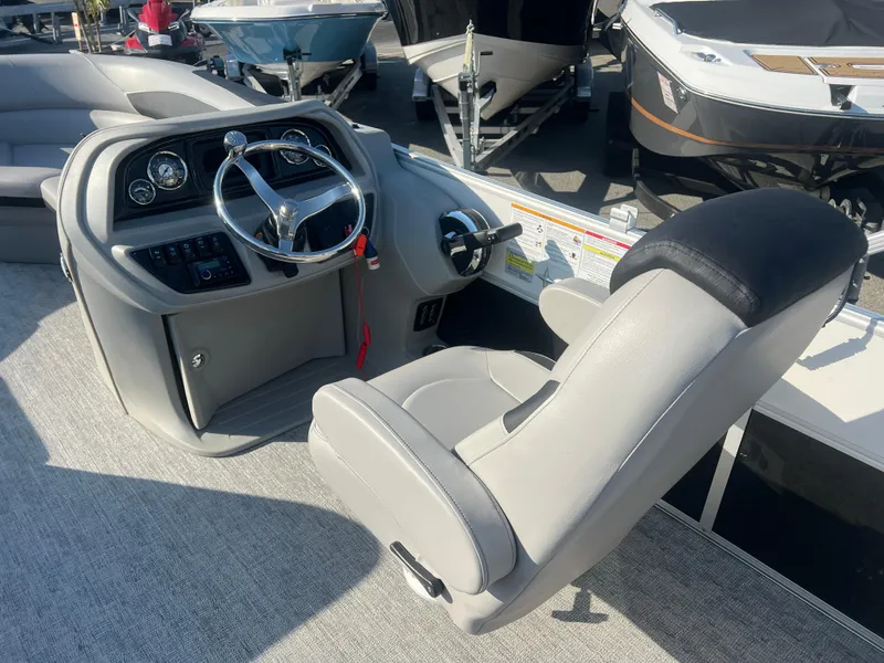 Slide: The Image of 2024 Berkshire 24RFX LE 2.75 boat cockpit with steering wheel and captain's chair. - 7