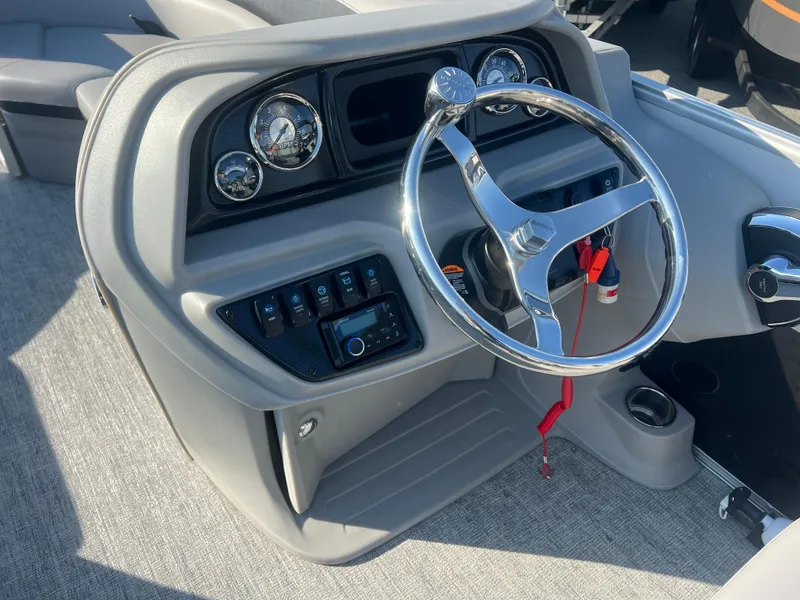 Slide: The Image of 2024 Berkshire 24RFX LE 2.75 boat dashboard with steering wheel and control panel. - 8