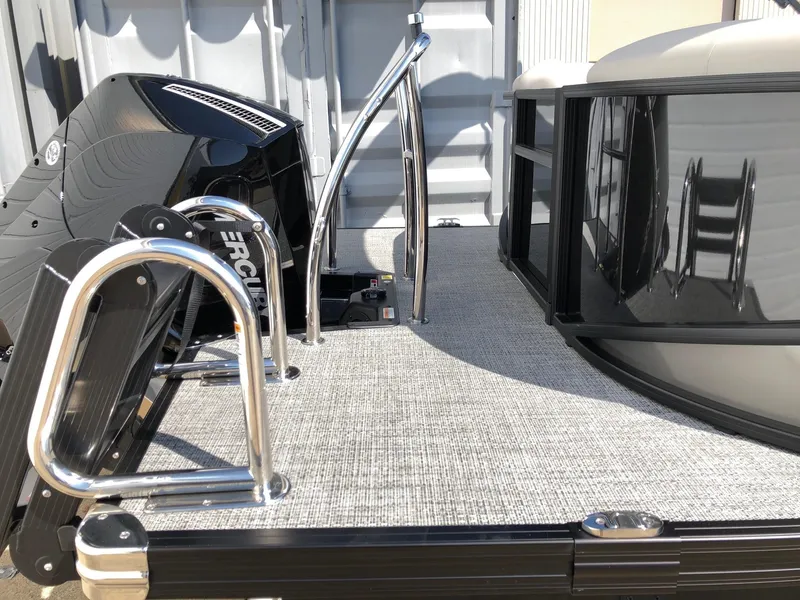 Slide: The Image of 2025 Barletta Cabrio 22QC boat deck with chrome railings and Mercury engine. - 3