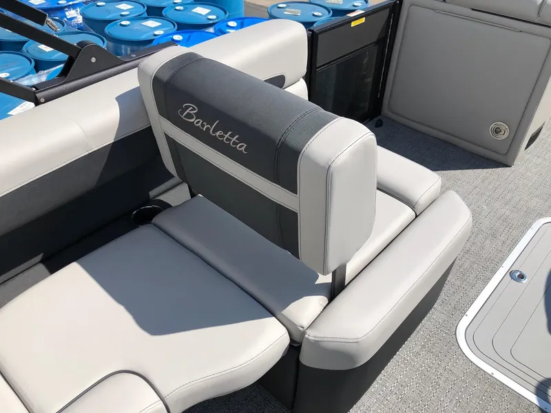 Slide: The Image of 2025 Barletta Cabrio 22QC boat interior with gray seating and logo embroidery. - 5