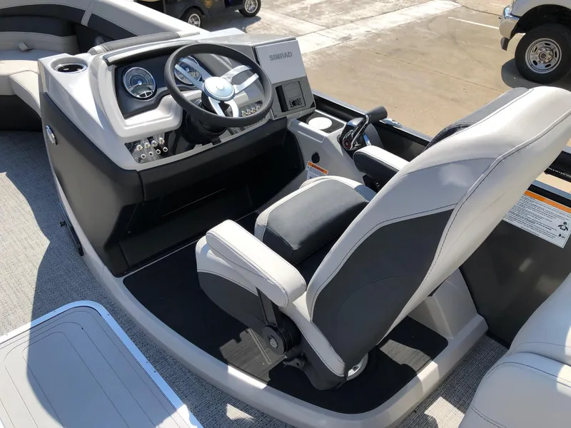 Slide: The Image of 2025 Barletta Cabrio 22QC boat cockpit with modern steering and comfortable seating. - 8