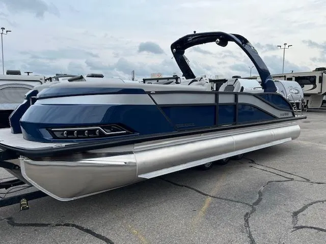 The Image of 2025 Harris Grand Mariner 250 pontoon boat in a parking lot, showcasing sleek design. - 0