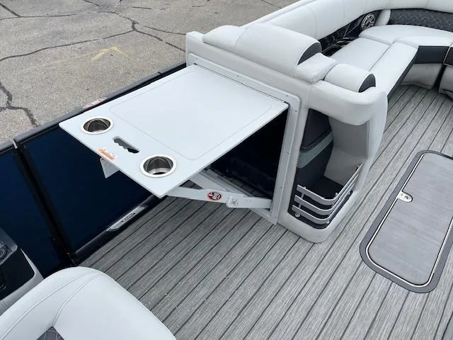 Slide: The Image of 2025 Harris Grand Mariner 250 boat interior with fold-out table and cup holders. - 12