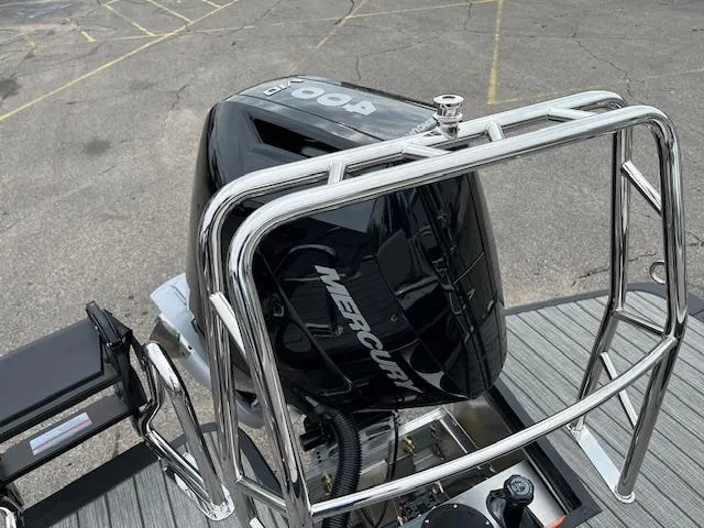 Slide: The Image of 2025 Harris Grand Mariner 250 with Mercury outboard motor, viewed from the rear deck. - 15