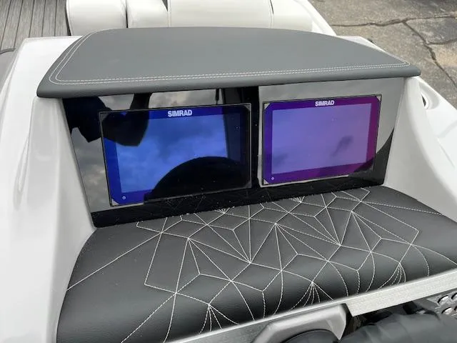 Slide: The Image of Simrad displays on 2025 Harris Grand Mariner 250 boat dashboard with stylish stitching. - 16